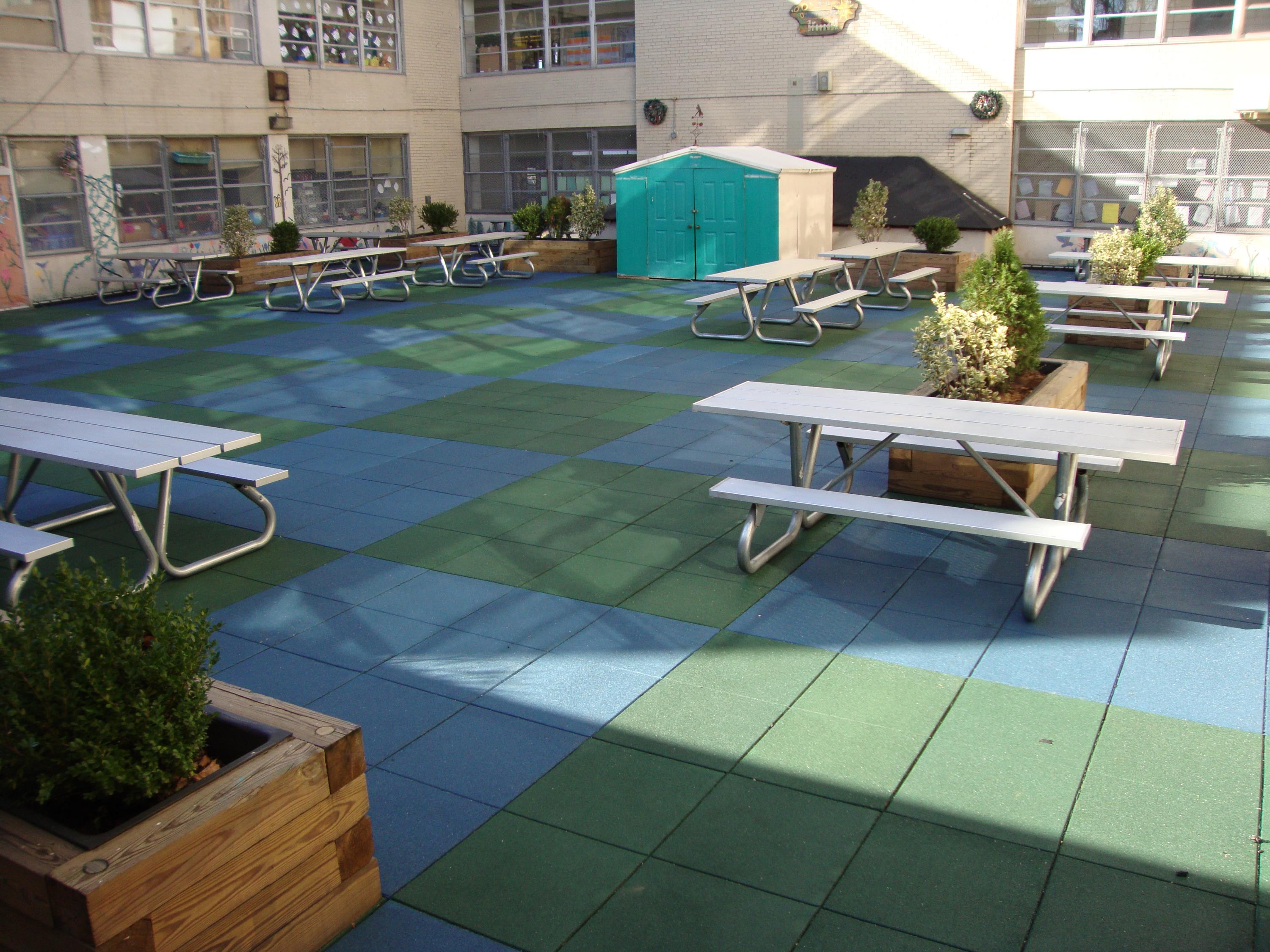 Public School Recreational Rooftop Playground Area Over Concrete Pavers b