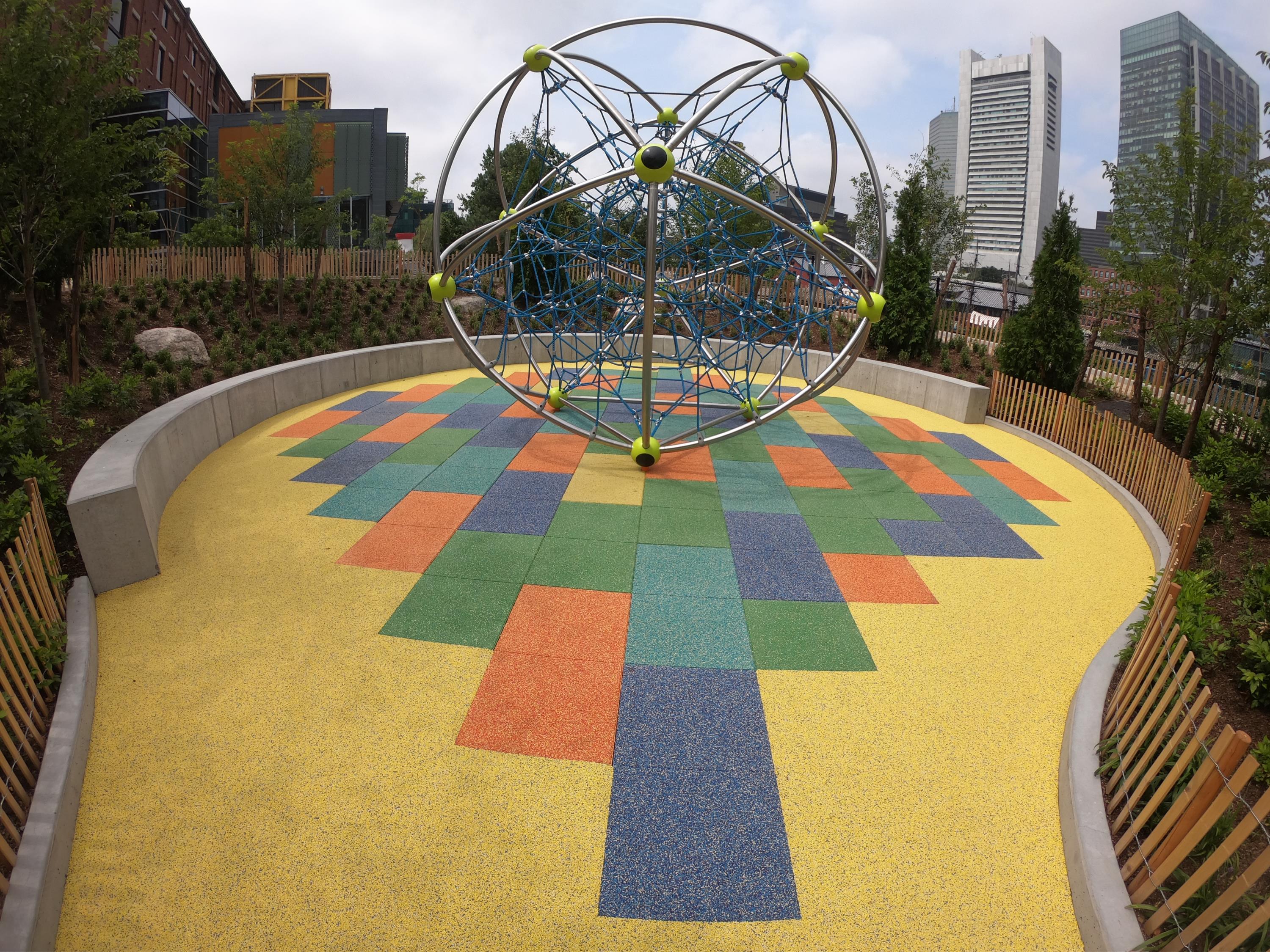 School playground surfacing with design using pigmented colors