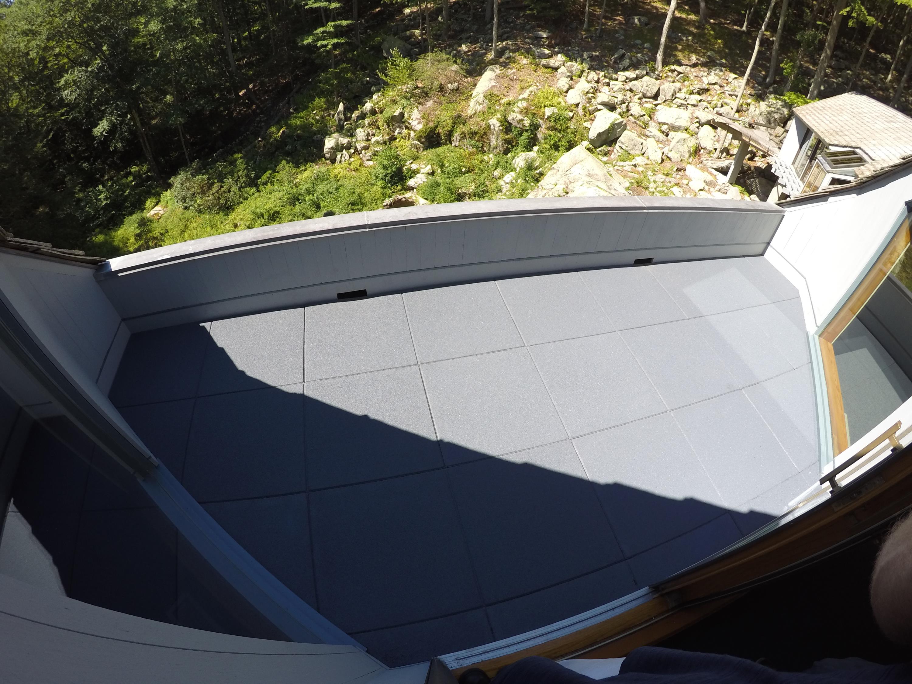 Rooftop patio area for this rural house in the hills using pigmented grey