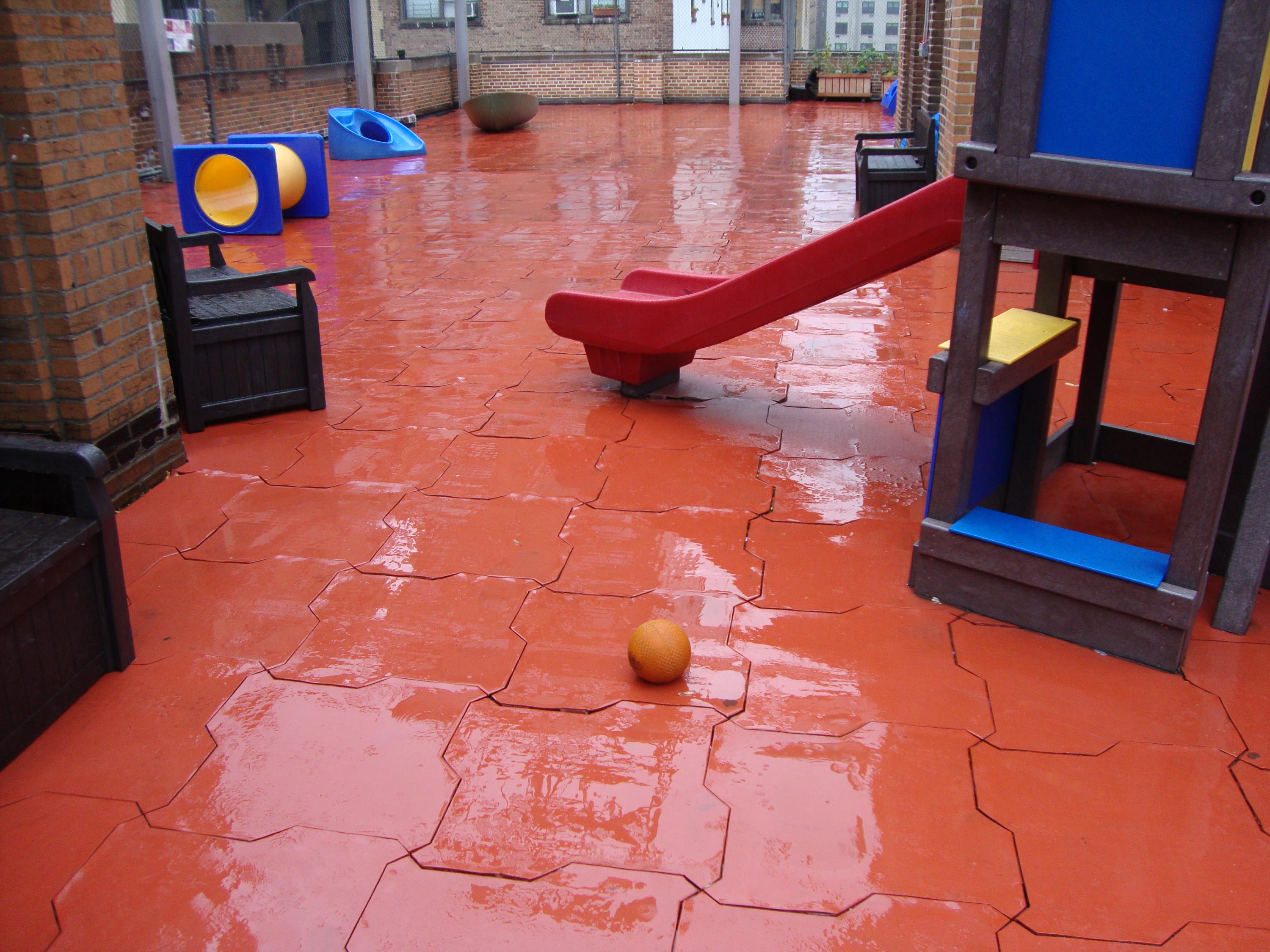 Rooftop Playground in need of a permeable rubber play tile a