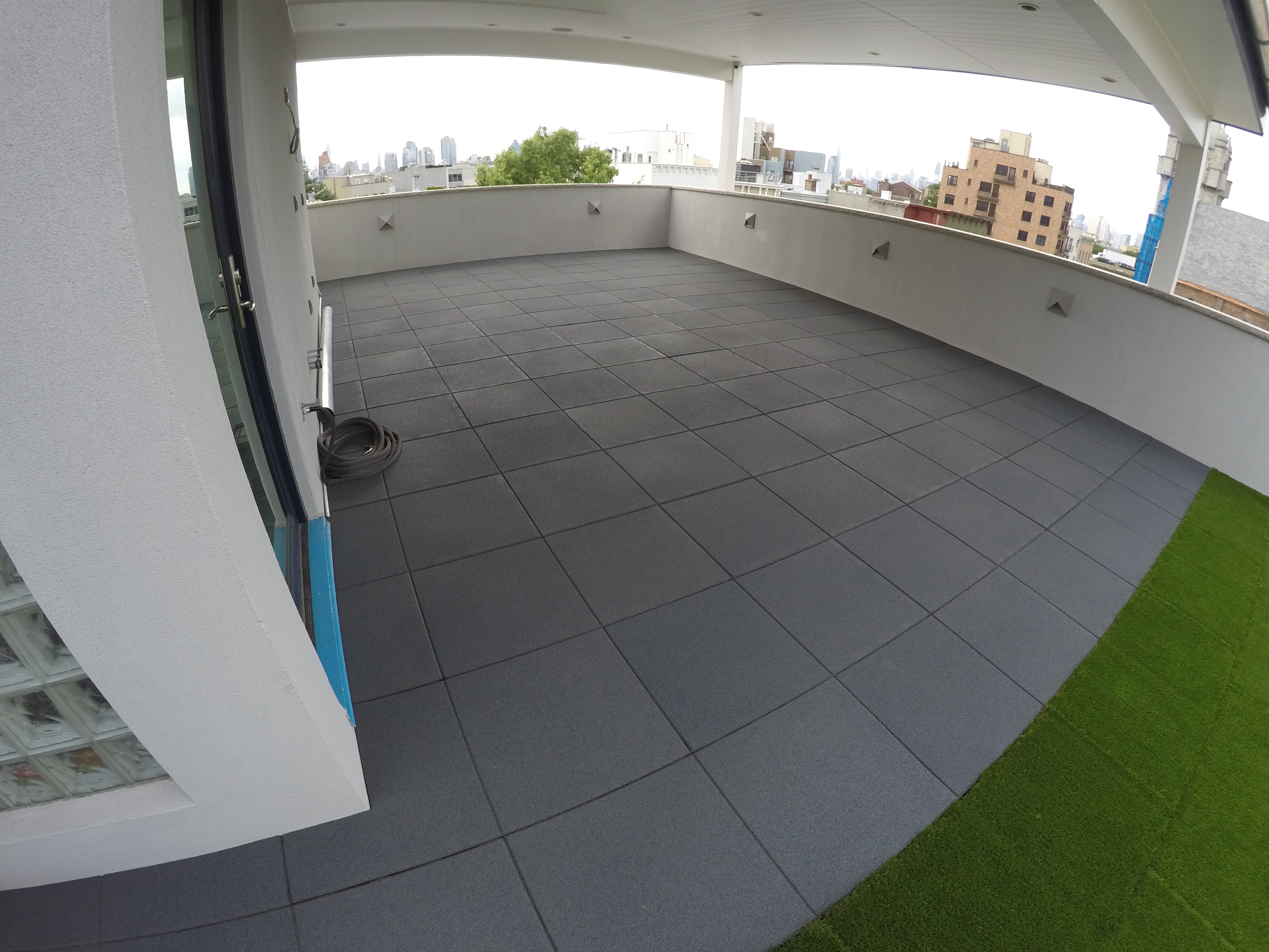 Our rubber tiles and our Turf-Top tiles on this rooftop patio area.