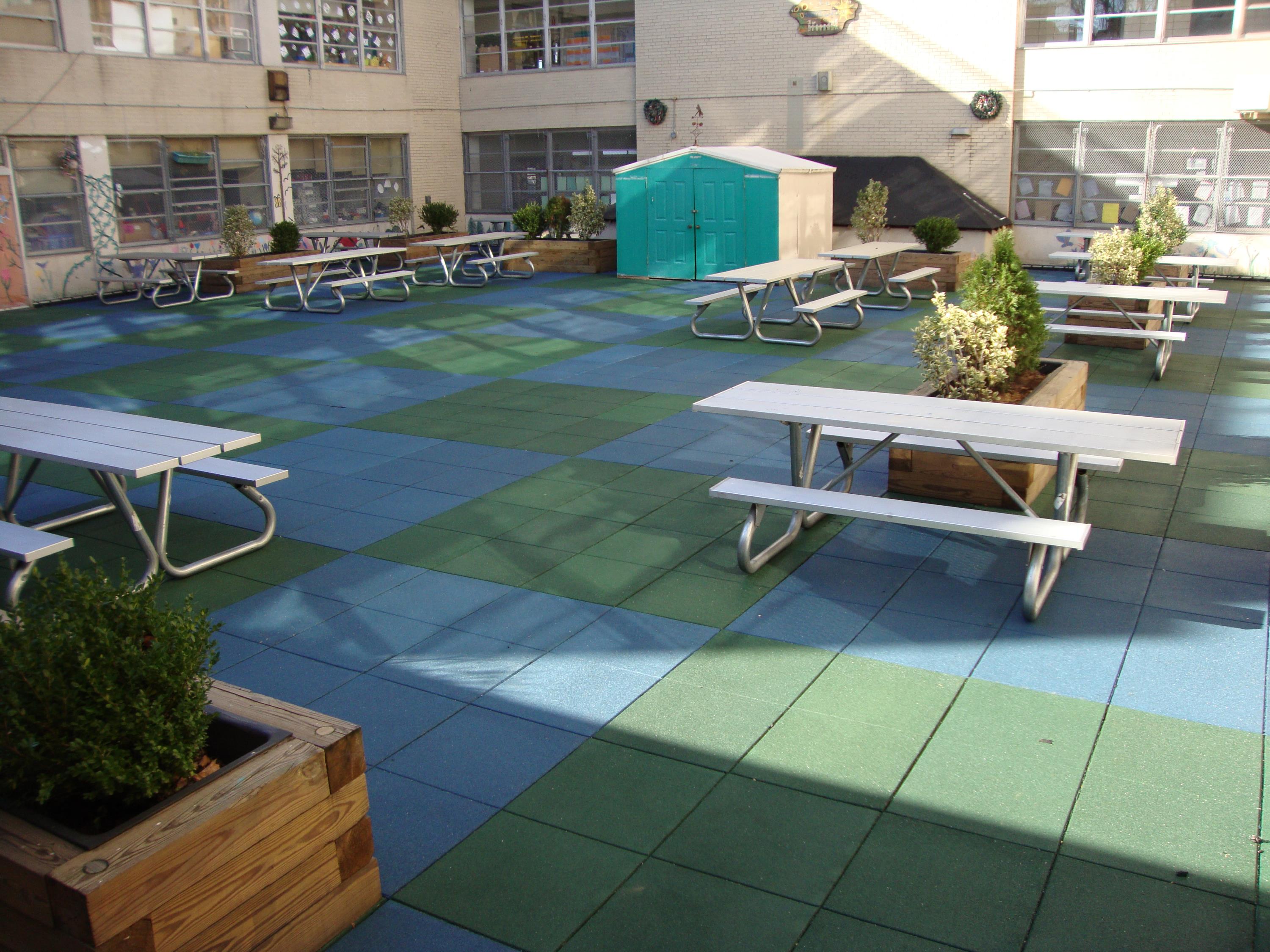 Public School Recreational Rooftop Playground Area Over Concrete Pavers b