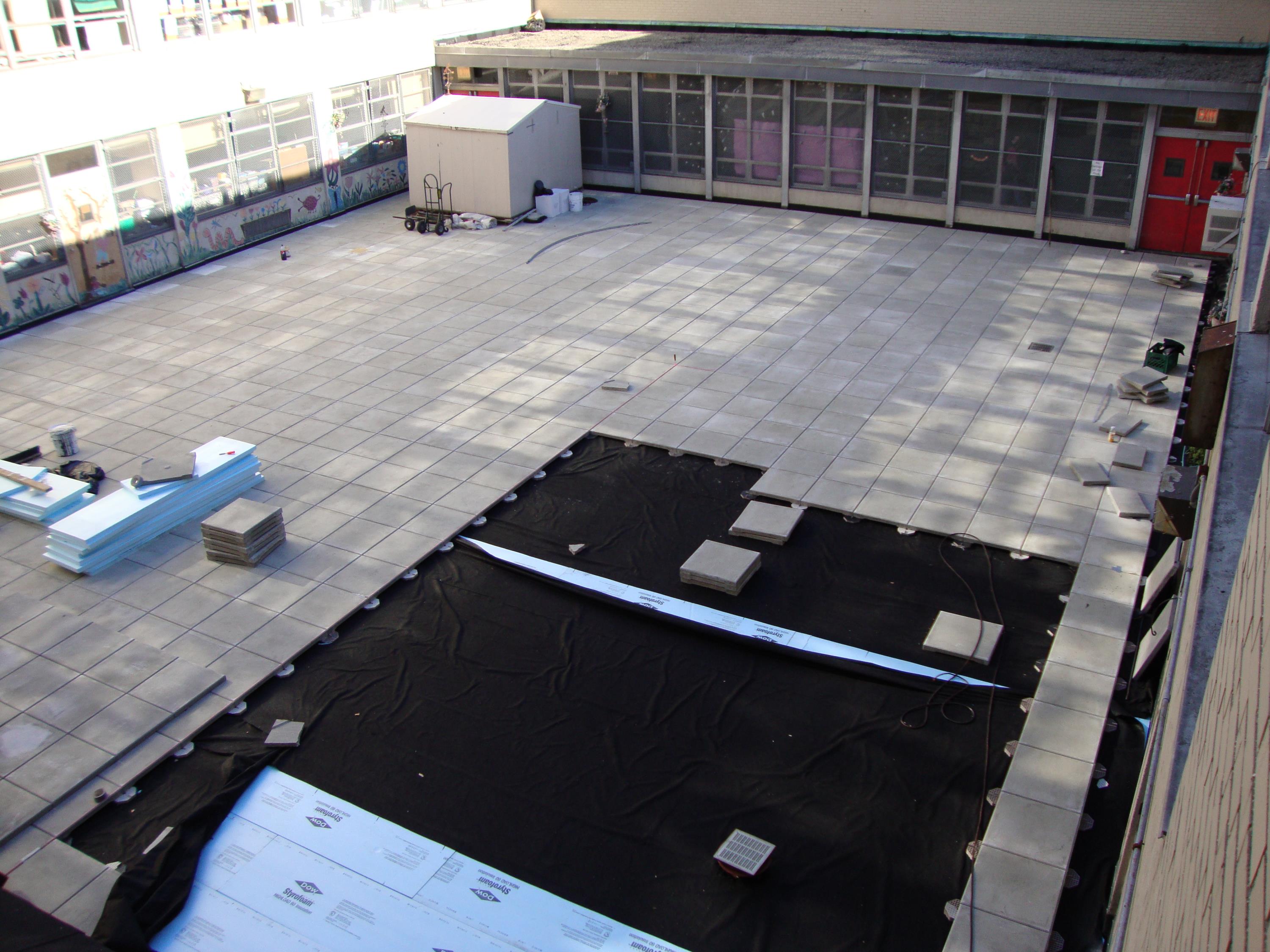 Public School Recreational Rooftop Playground Area Over Concrete Pavers c