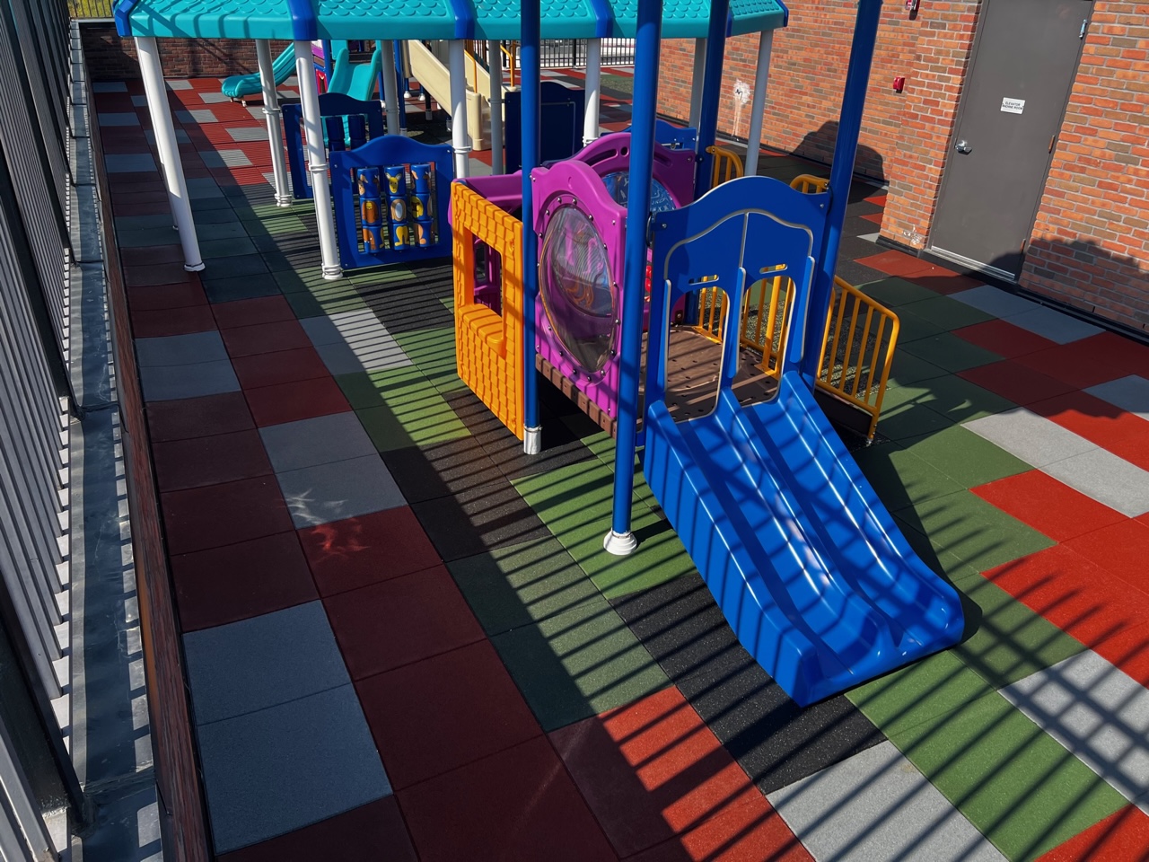Charter School Rooftop Playground Using Bright Pigmented Colors