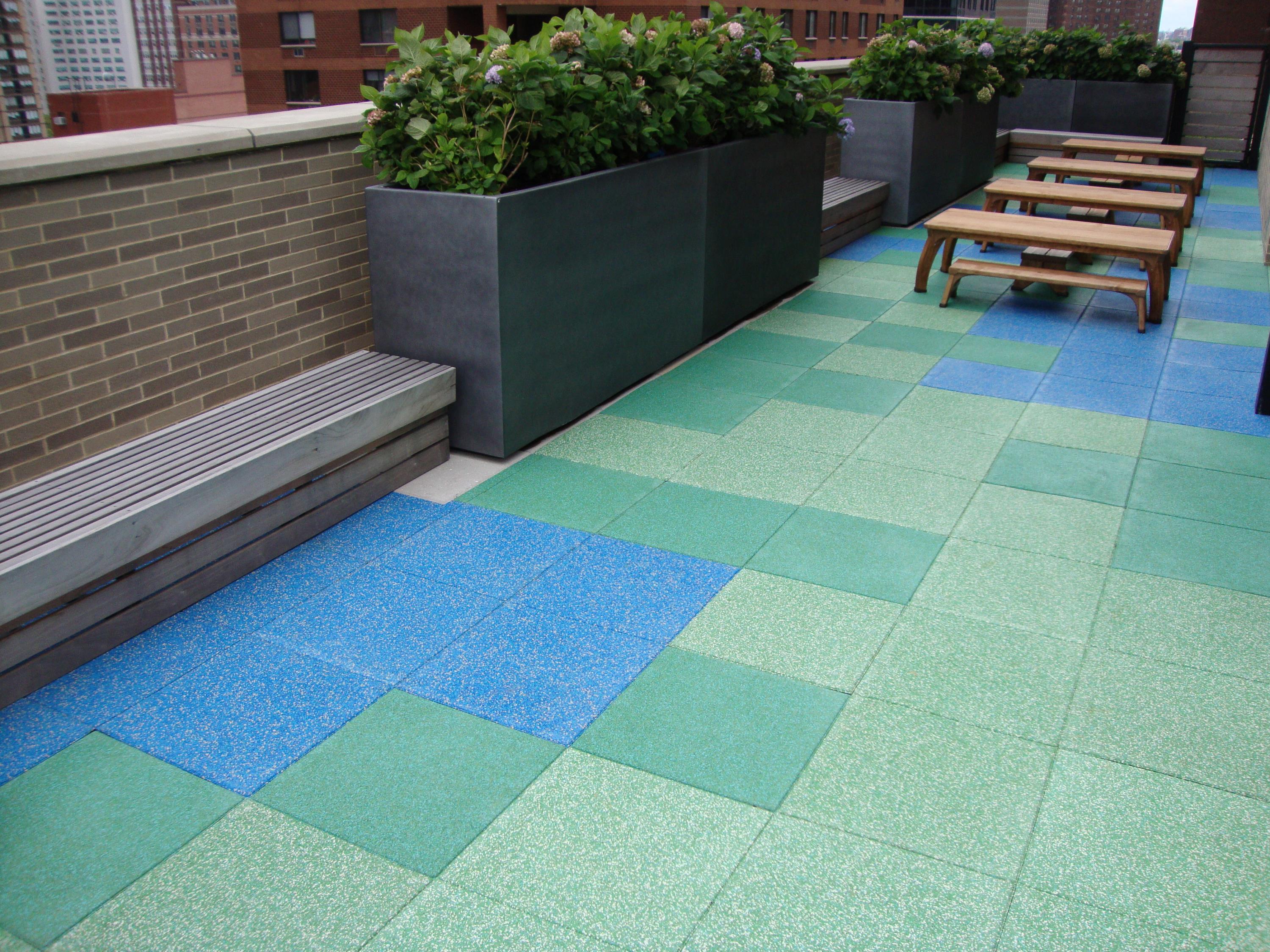 Rooftop playground area that is also used as a patio area