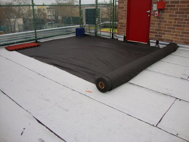 Rooftop Paver Application showing the Fabric/Mesh being applied.