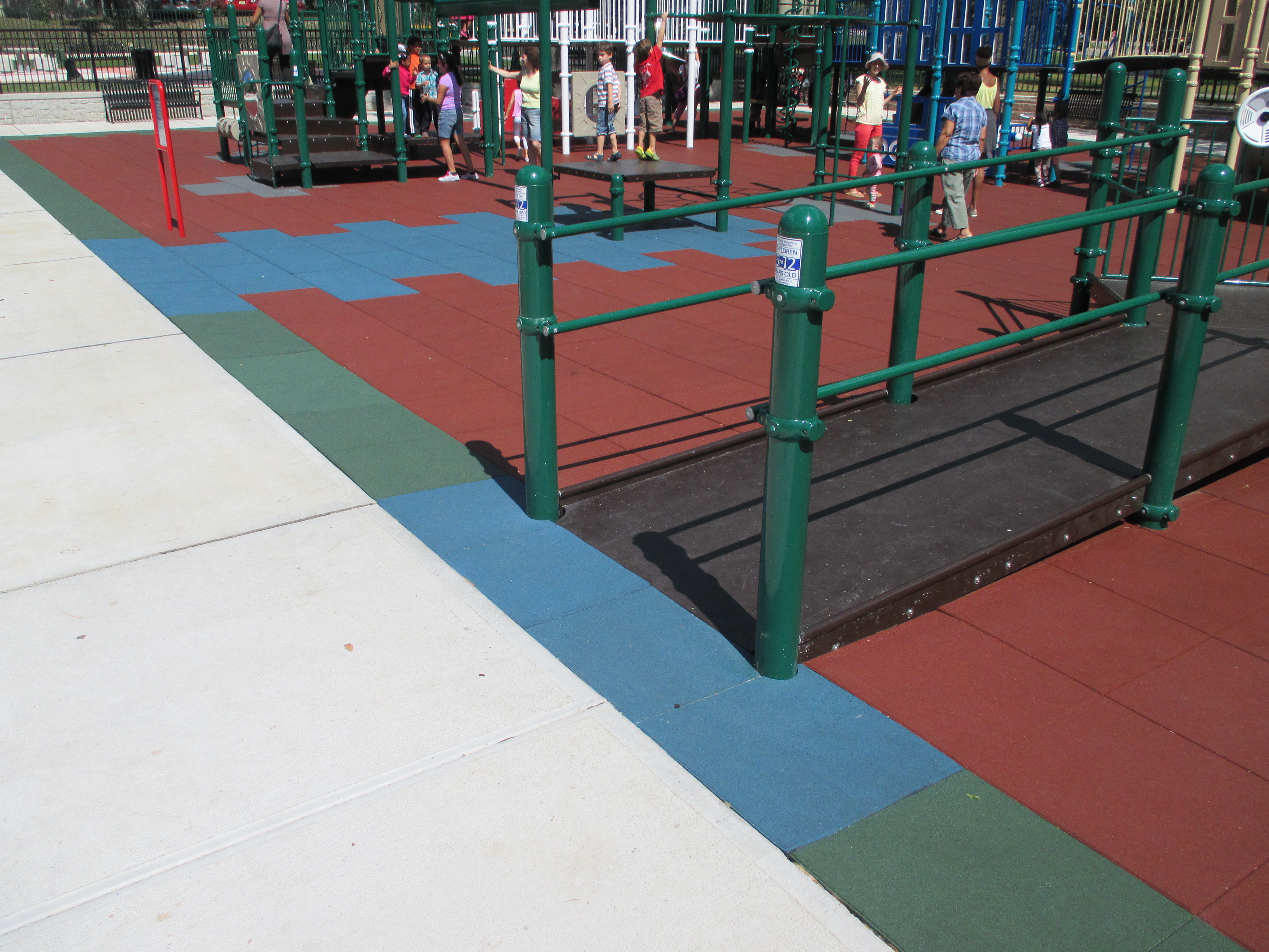 Wheelchair accessible playground tiles that is ADA compliant